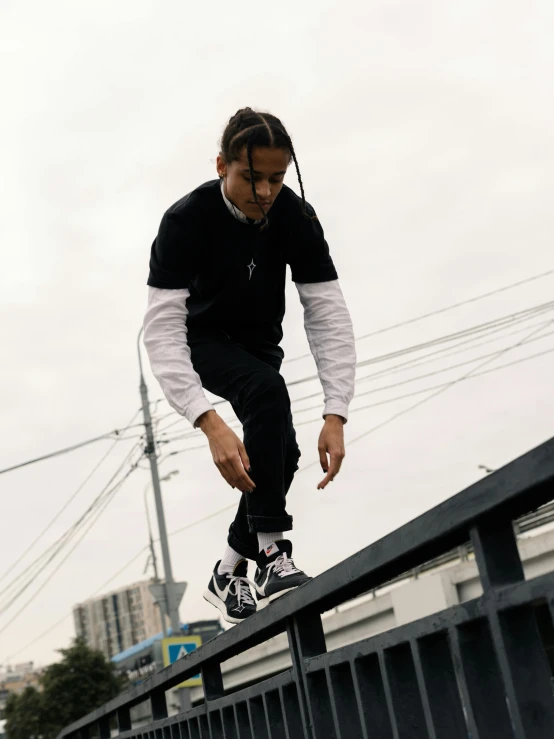 a man skateboarding on a railing over a parking lot