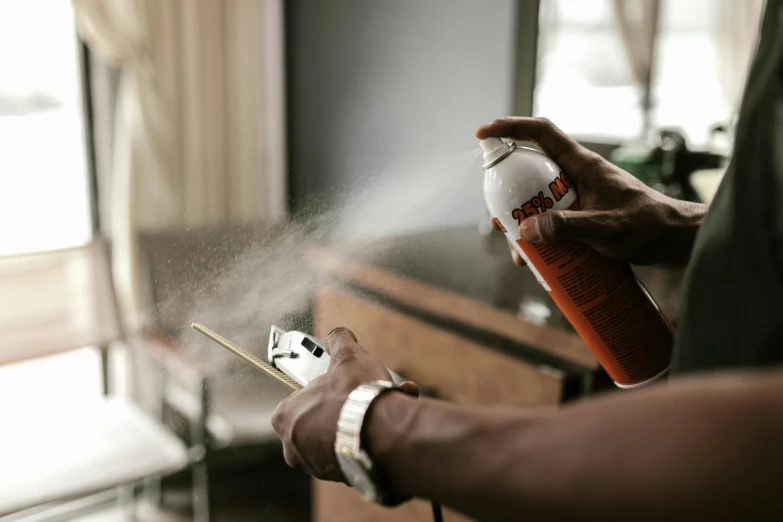a person spraying some sugar on his hand