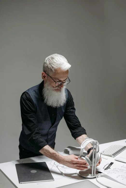 an older man working on his paper on a table