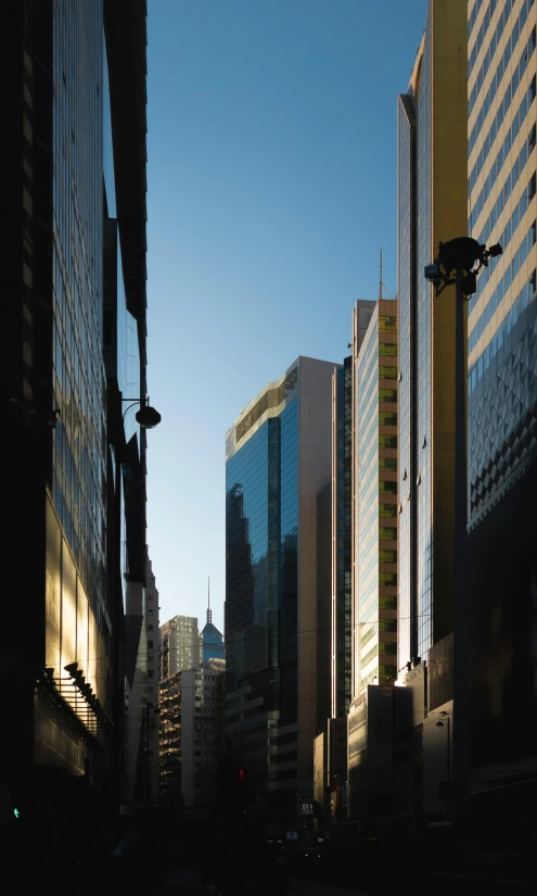 city buildings against a blue sky at sunrise