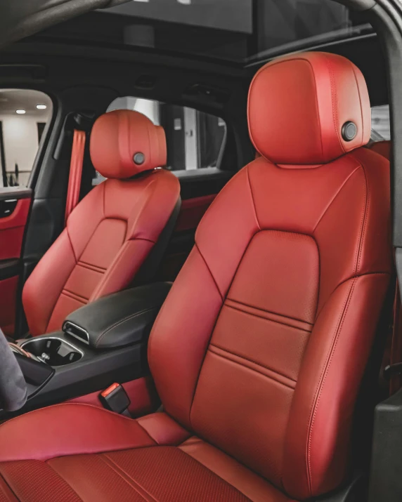 a row of red seats inside a vehicle