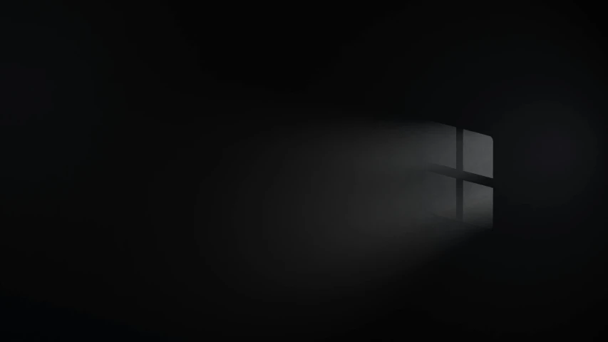 a cross is seen through a window on a dark background