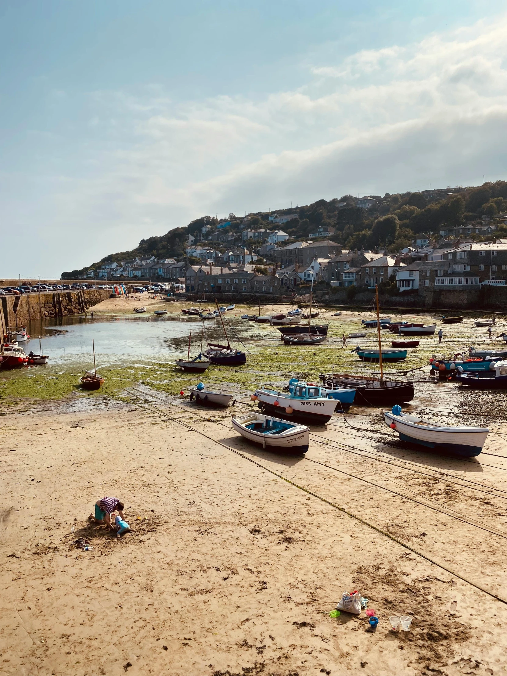 boats are parked on the sand at the harbor