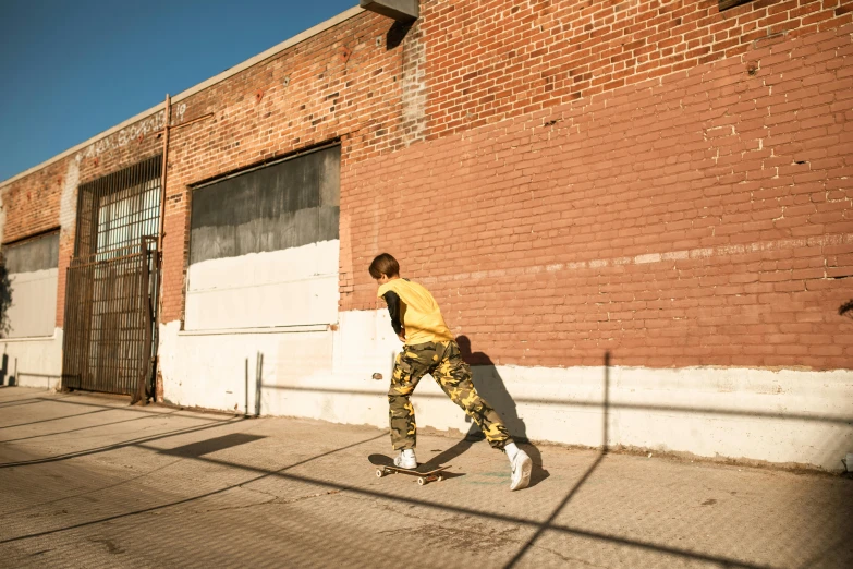 a man riding on a skateboard down a sidewalk