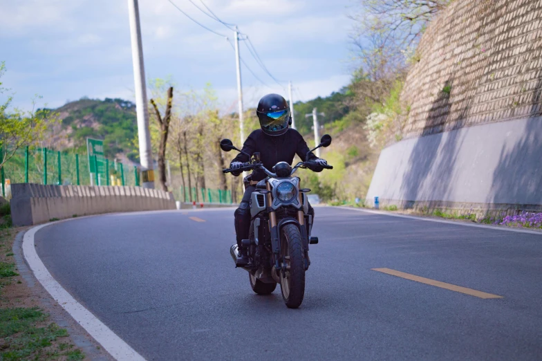 a man is riding a motorcycle on the road