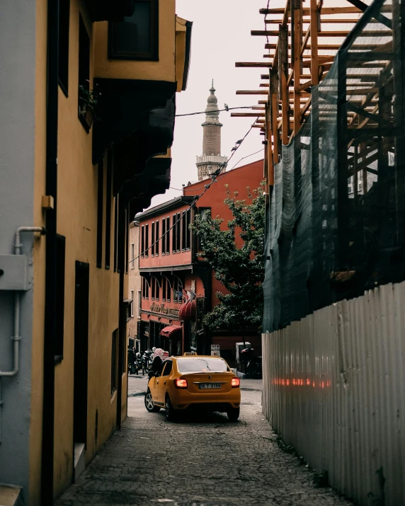 a street scene with focus on a parked yellow cab