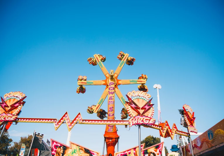 an amut park rides on a sunny day