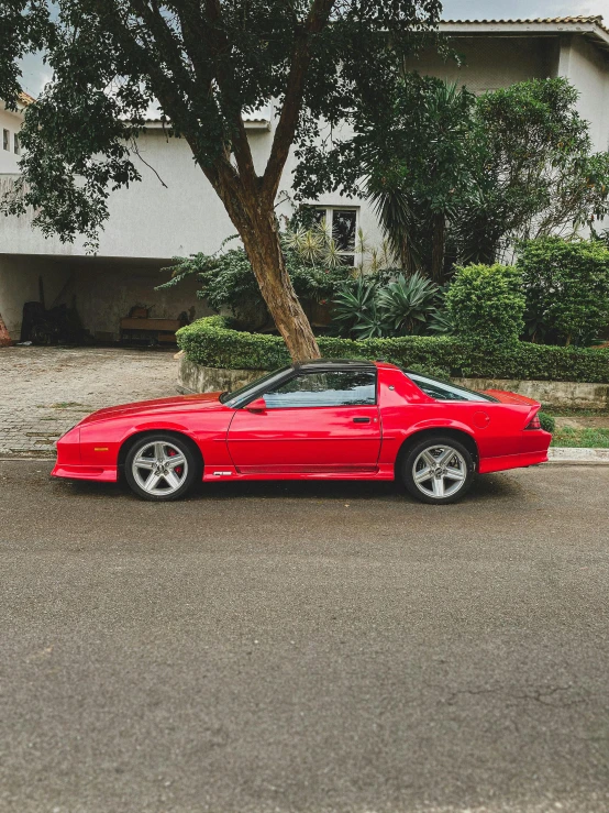 a red sports car parked on the side of the street