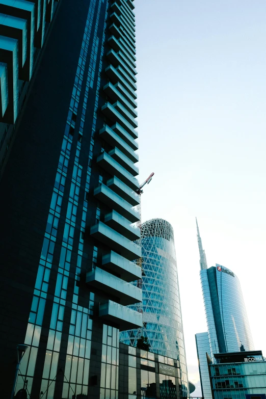 a modern office building with a plane flying by