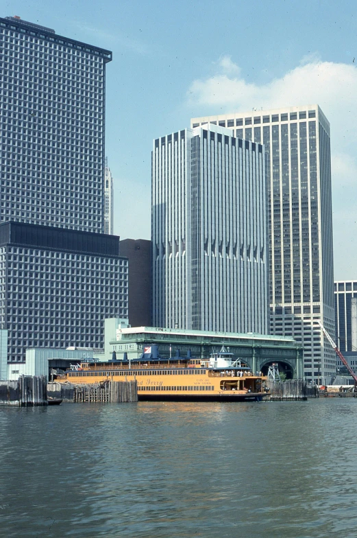 a boat on water next to a large city