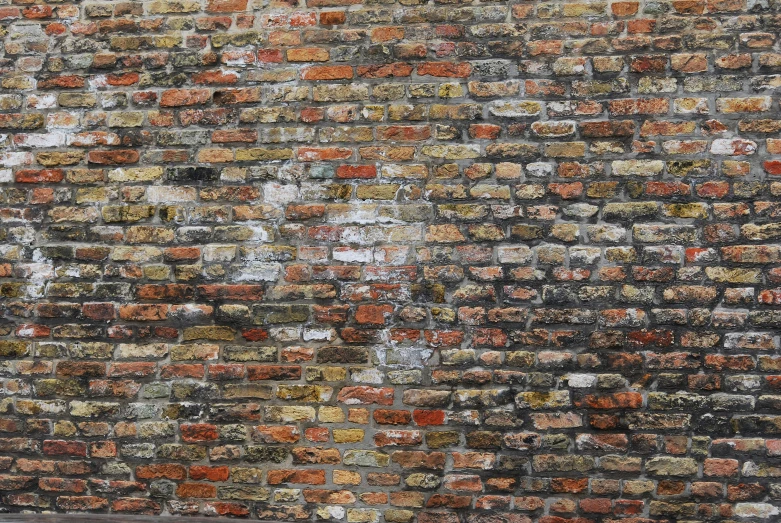 a brick wall that has faded paint on it