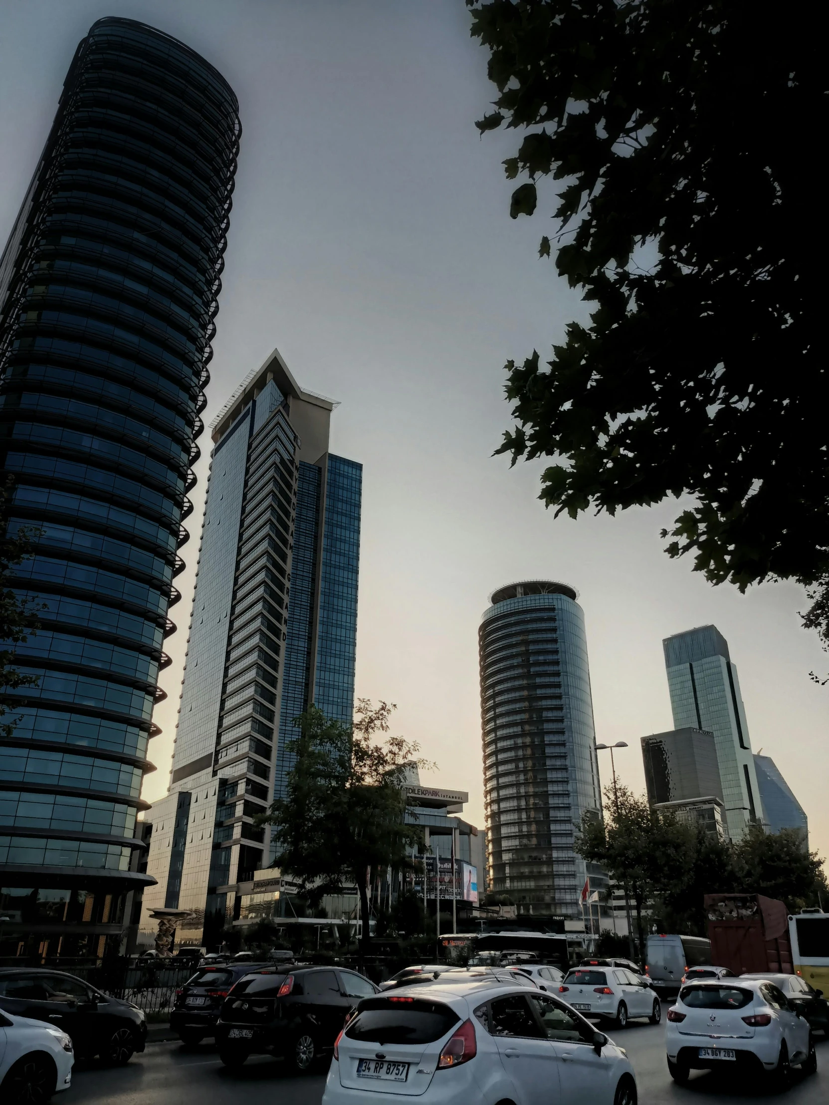 cars driving down a street in front of tall buildings