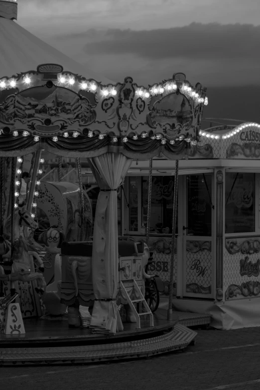 an amut ride with lights on it and a man walking in front