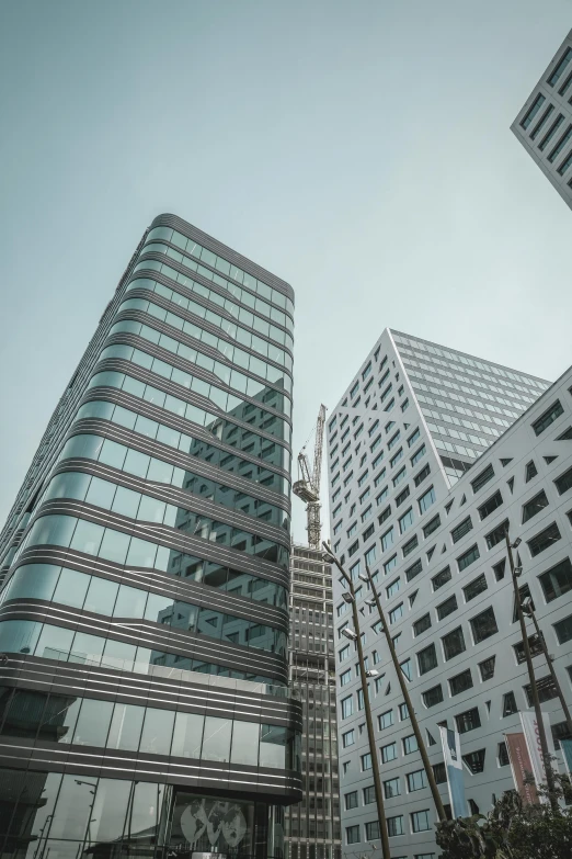 a very tall building sitting next to two buildings