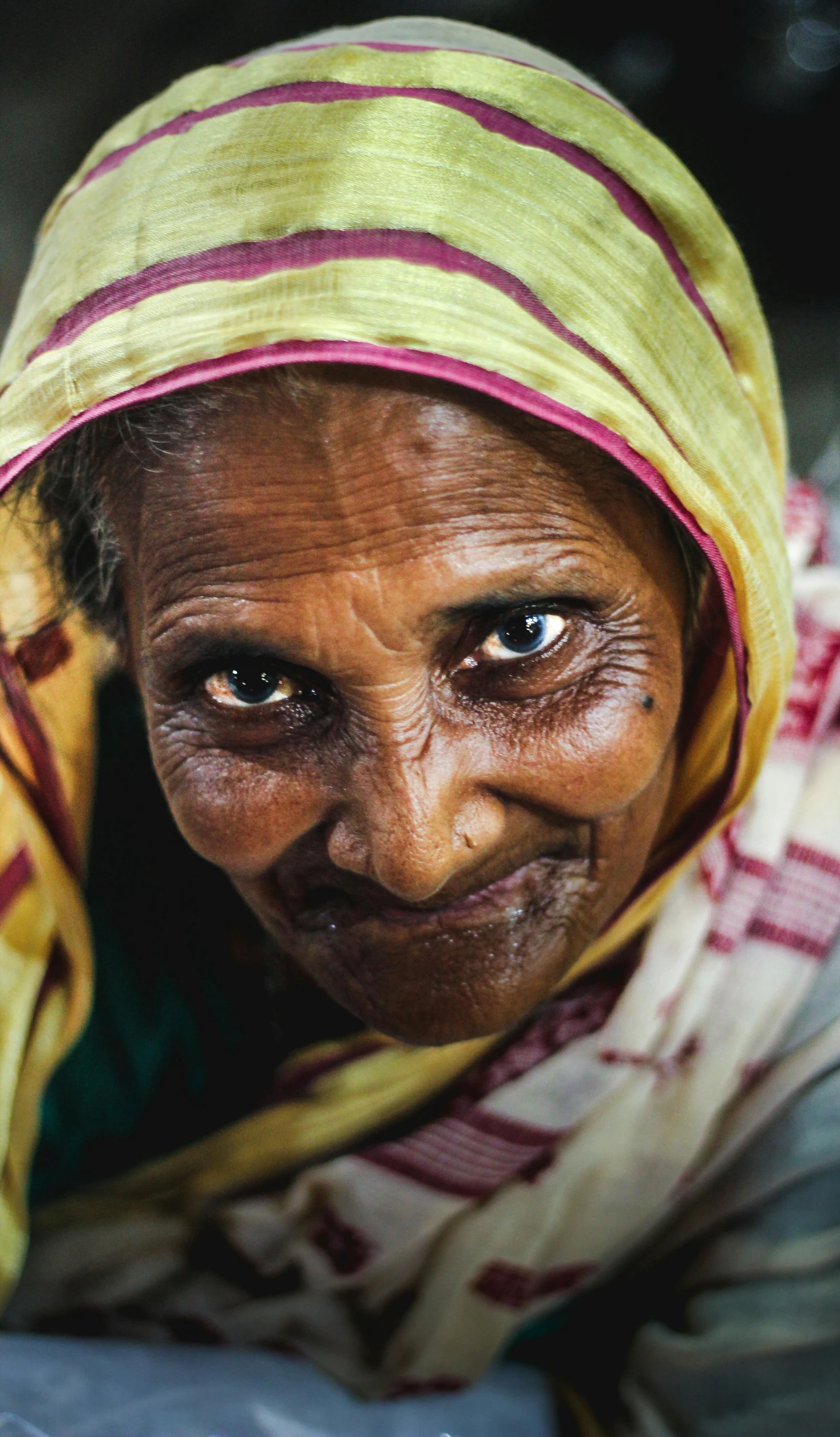 a woman with blue eyes is smiling at the camera