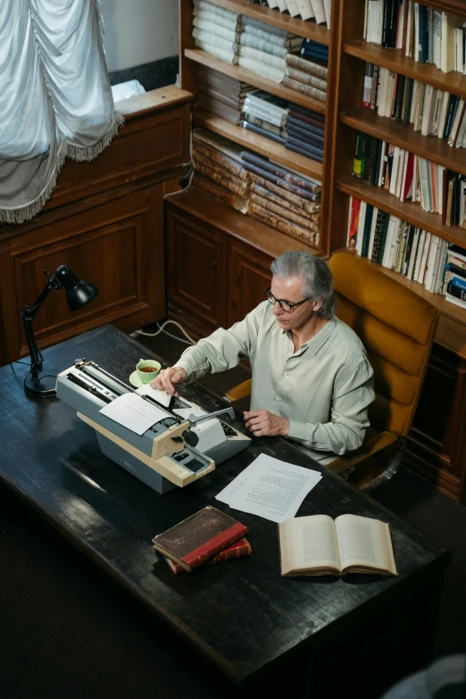 an older gentleman sitting in his liry with a typewriter