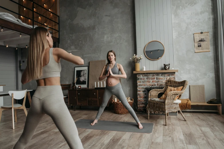 a woman is performing some yoga moves in her room