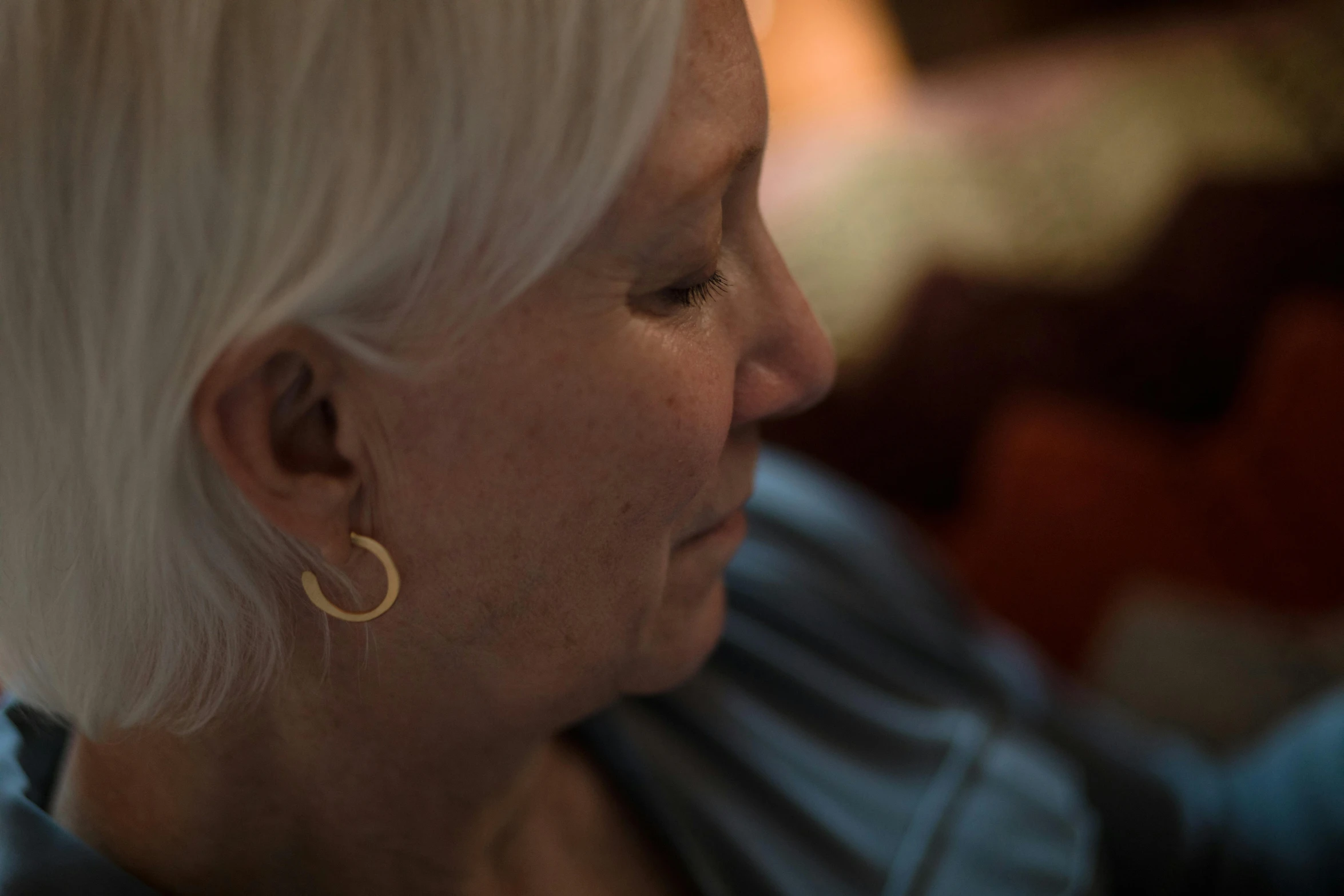 a woman with a short blonde hair sitting down