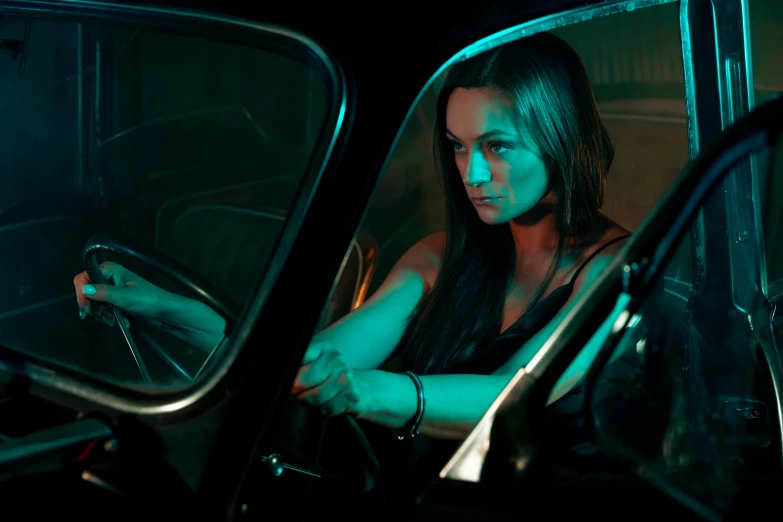 a woman is sitting in the driver seat of a car