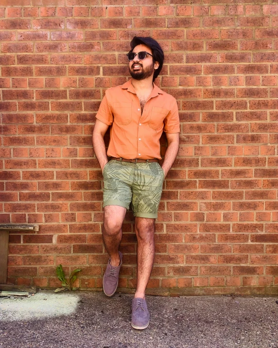 a person standing next to a brick wall