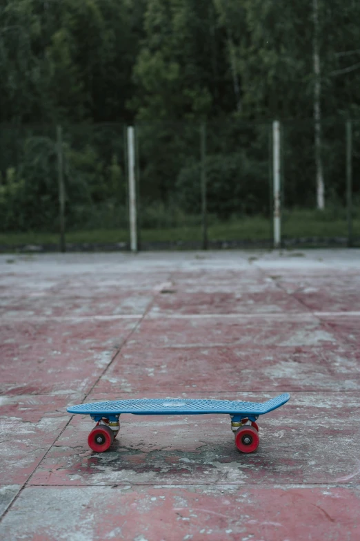 an empty basketball court with a broken skateboard