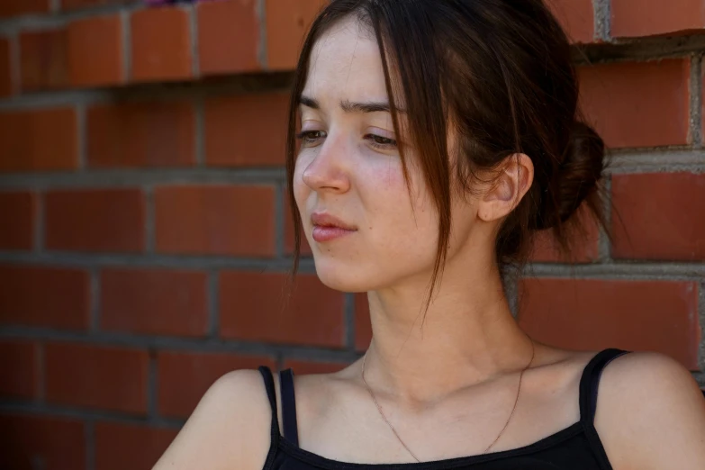 a young woman looking down with serious looks on her face