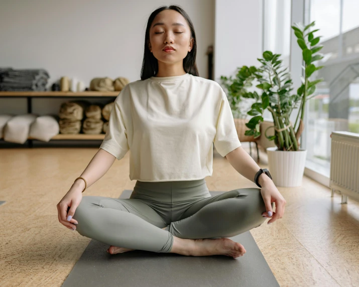 a woman is doing yoga in the middle of a room