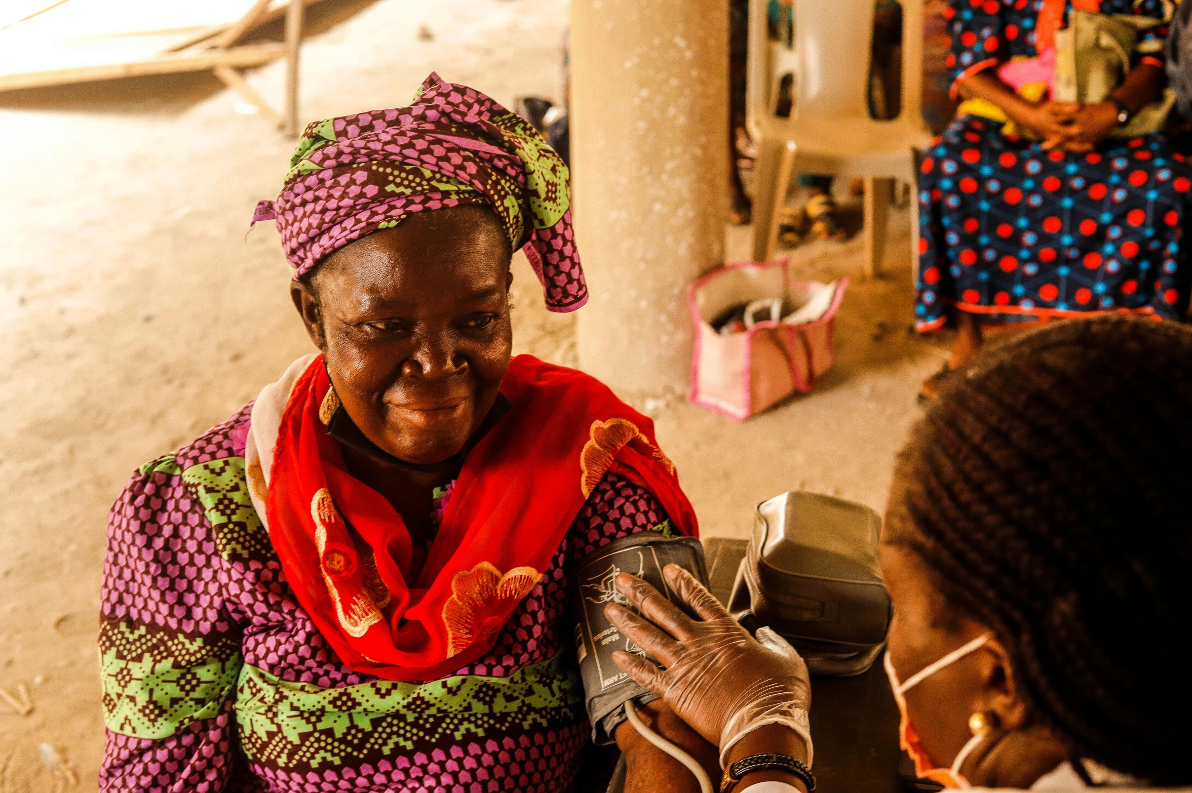 two women in colorful clothing talking to each other