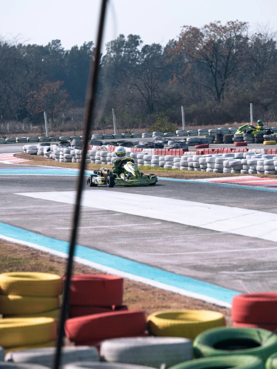 a green race car racing down the road