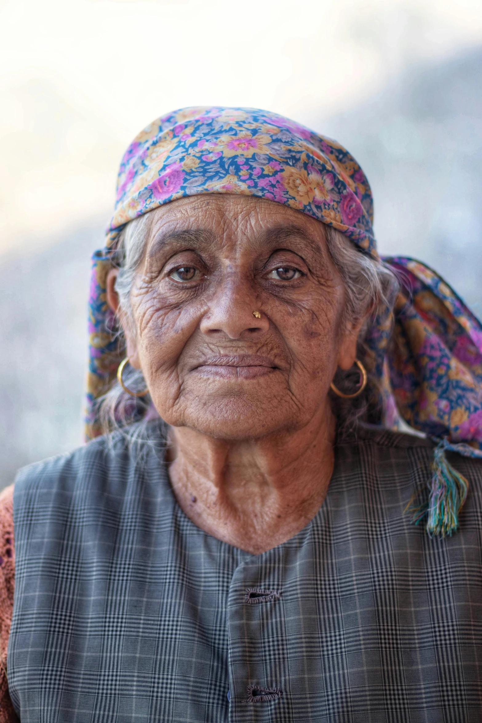 an elderly woman is posing for the camera