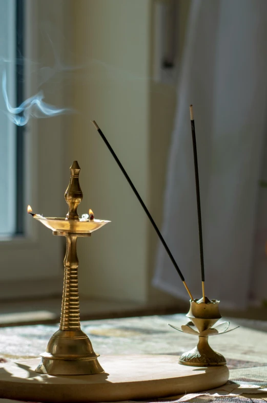 a close up of two small incenses on a table