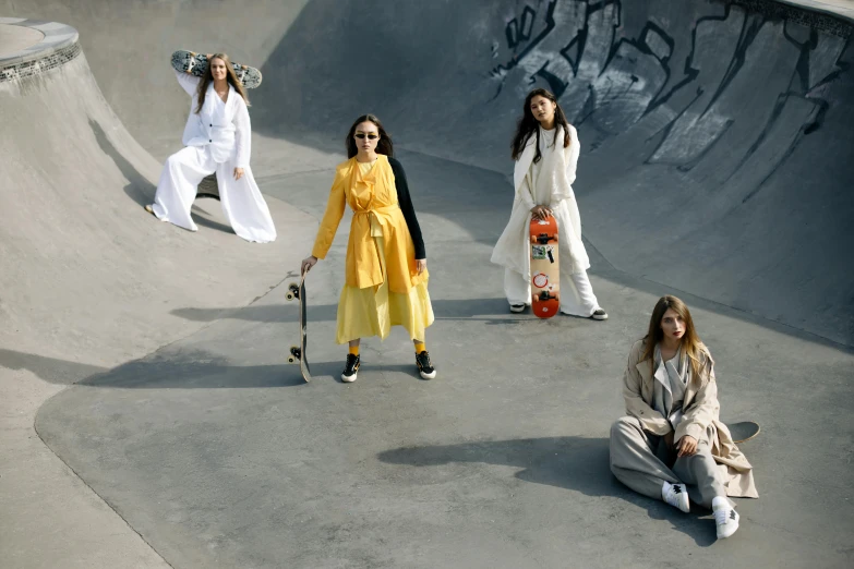 a group of young ladies sitting around a skate park