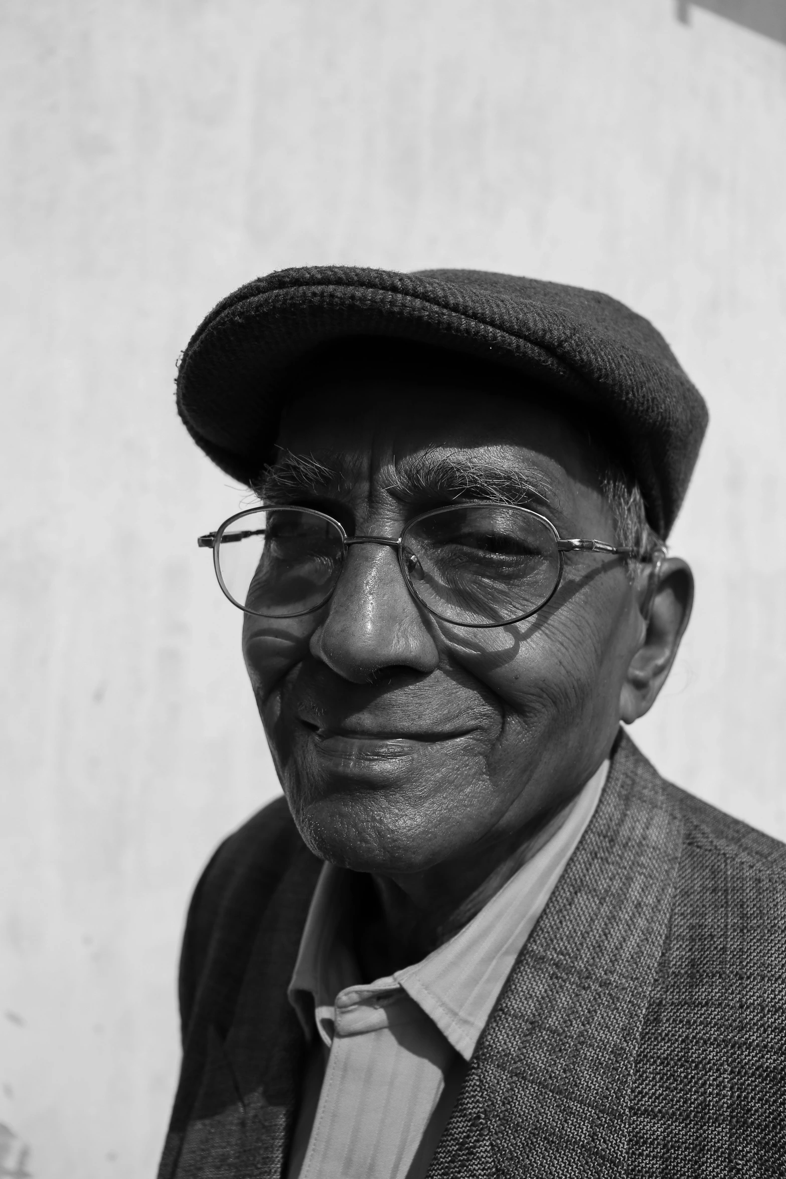 a black man wearing glasses and a hat