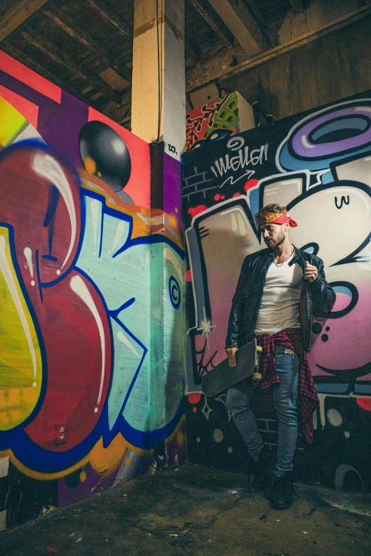 a man is standing next to graffiti art