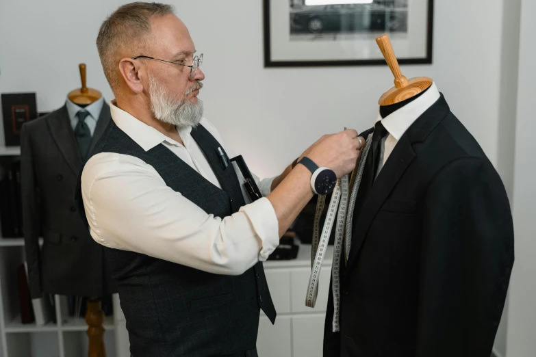 an older man is placing on his jacket