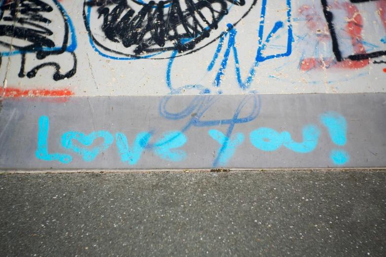 a skateboarder on the ground covered in graffiti