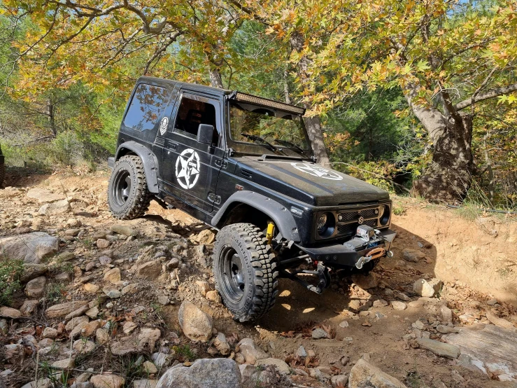 a jeep is riding up a dirt hill