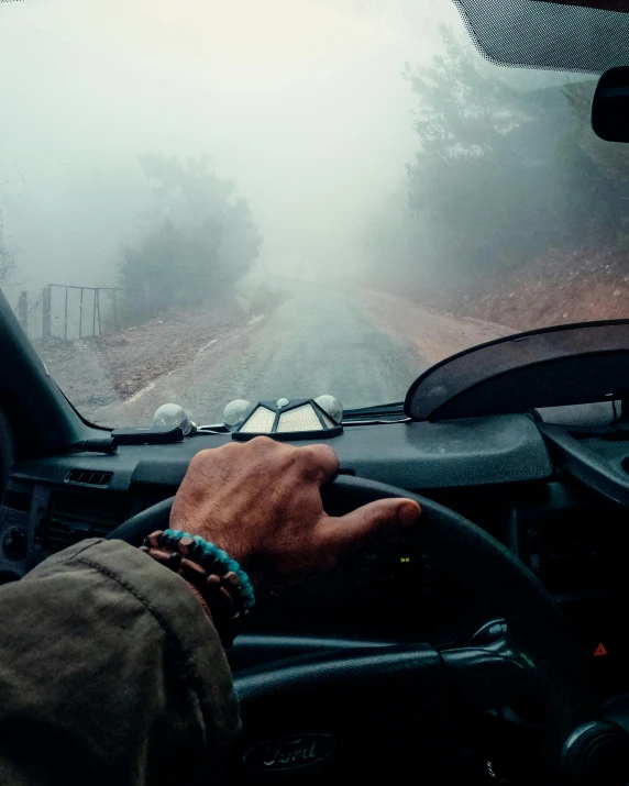 a person sitting in the drivers seat of a vehicle