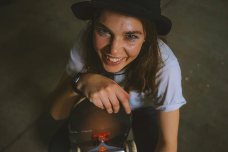 the woman smiles while holding onto the kettle