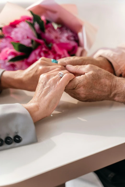 an old and young bride holding the hand of an older lady