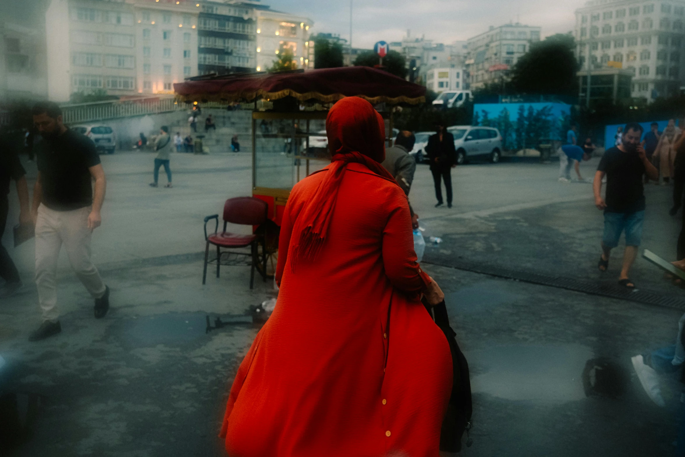 a woman is walking through the street near some buildings