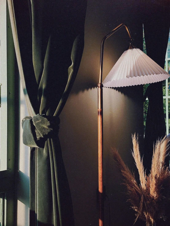 a tall lamp is next to a decorative vase on the shelf