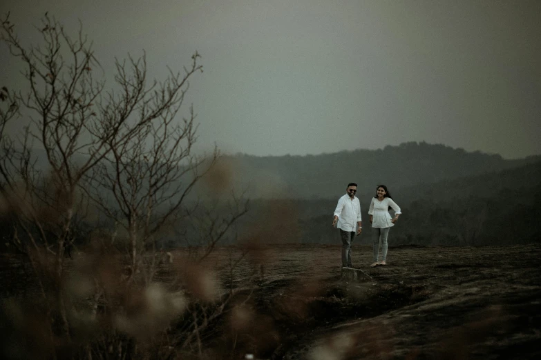 a couple of people that are standing in the dirt