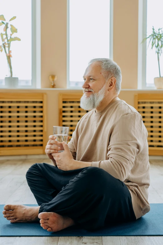 an old man holding a glass in his hands