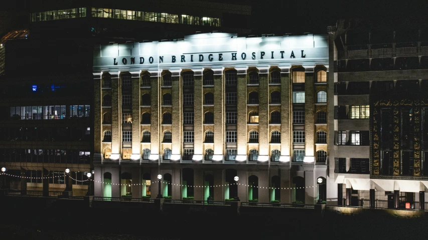 large illuminated building at night lit up with neon