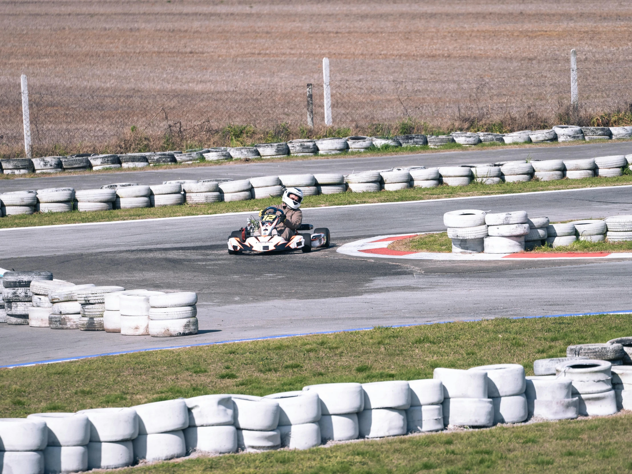 a group of people driving around an oval track