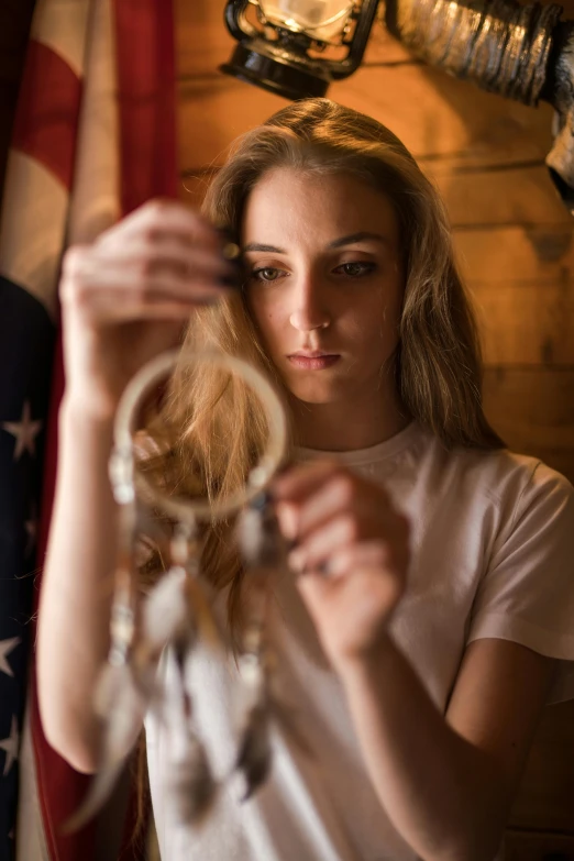 a woman looking down at some keys hanging from a hook