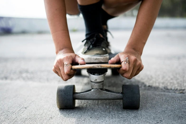 a person riding on a skateboard on the road