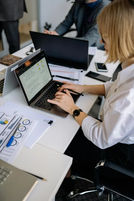 a woman on her laptop sitting at a table