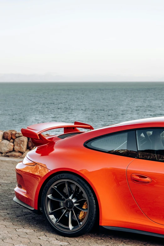 a car parked near the water with its door open